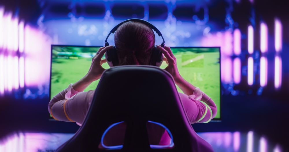 Female Online Gamer Playing Video Game in a Futuristic Cyberpunk Room.