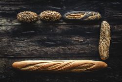 Assorted gold homemade bread on dark wood background