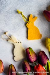 Top view of yellow decorative rabbit with bunch of tulips 5oDQxG