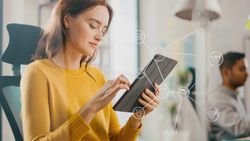 Virtual Connection Visualization Concept: Happy Young Woman Uses Digital Tablet Computer in the Office. Infographics Illustrate Cloud Computing,