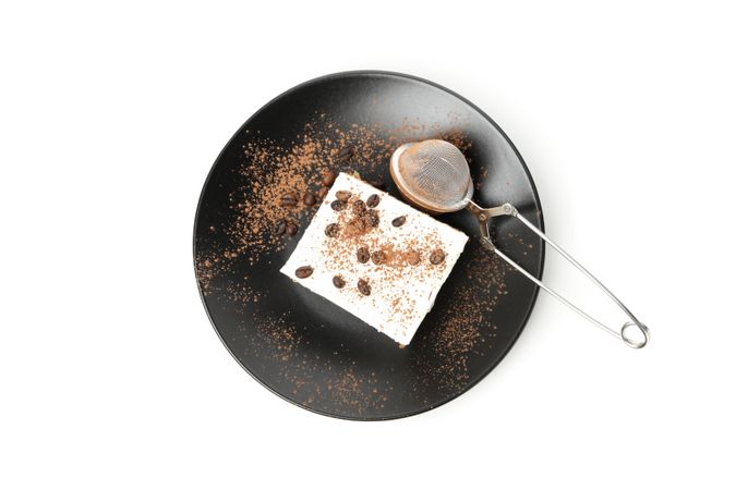 Plate with tiramisu isolated on light background. Tasty dessert