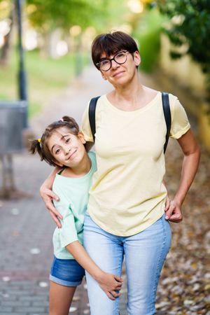 Mother and daughter standing outside together