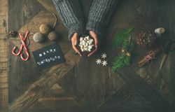 Homely holiday with “Merry Christmas” card, woman with hot chocolate, copy space