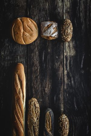 Assorted gold homemade bread on dark wood background