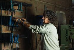 Man using carpentry tool in workshop