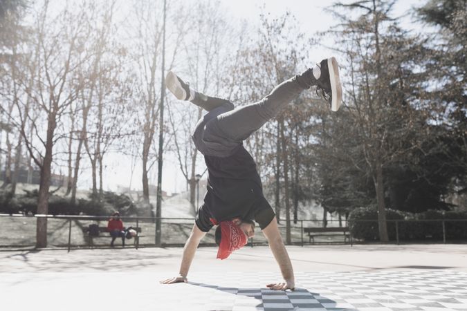 Man dancing break dance in park