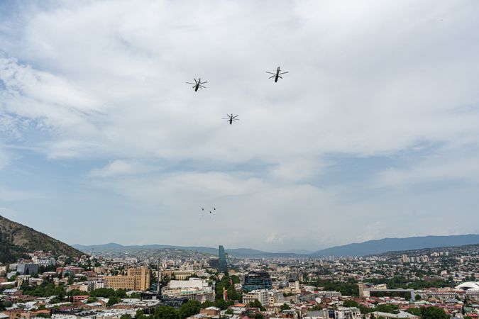 Helicopters fly in the sky of Tbilisi city