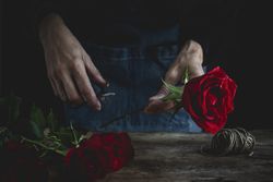 Unrecognizable woman making a bouquet of red roses