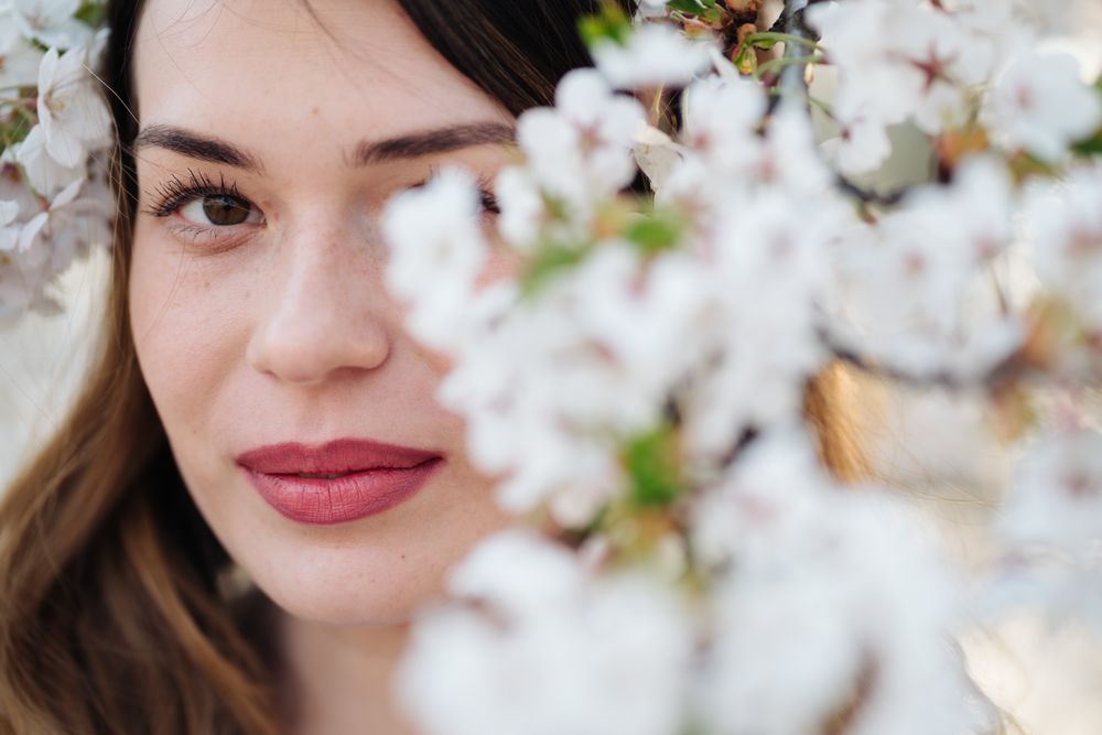 woman amidst white flowers