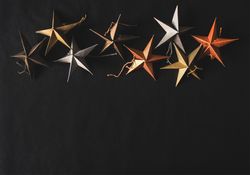 Flat-lay of colorful paper toy decorative stars, close together