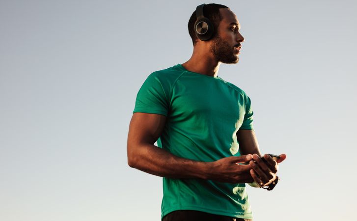Male athlete listening to music during workout