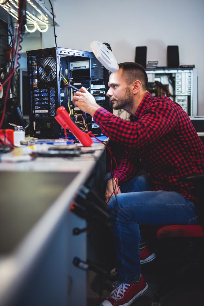 Man repairing PC at workplace