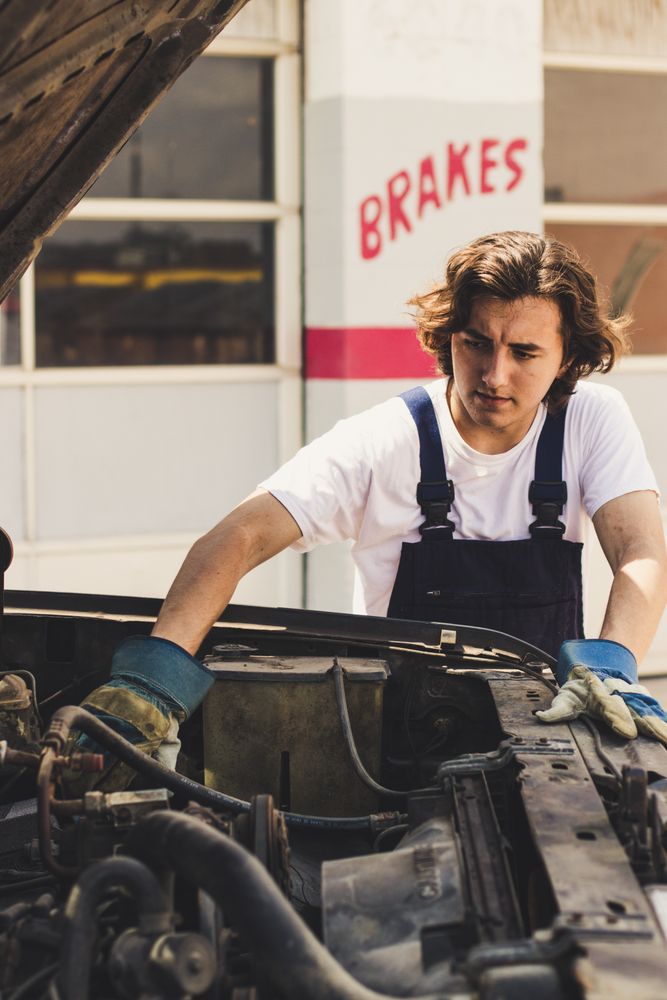 Mechanic fixing vehicle engine