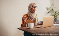 Muslim woman having a zoom meeting call on her laptop bGKYAb
