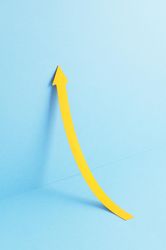 Yellow arrow pointing up while leaning on the wall