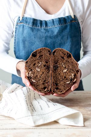 Hands of woman holding rye bread