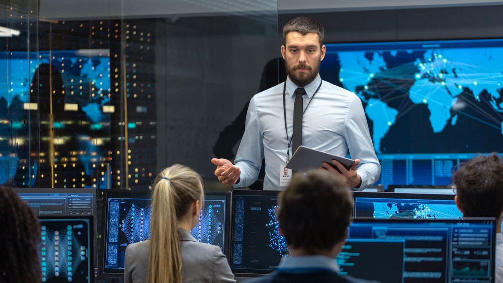 Chief Project Engineer Holds Briefing for a Team of Scientists that are Building Machine Learning System.