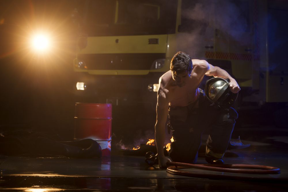 Muscular firefighter on mission