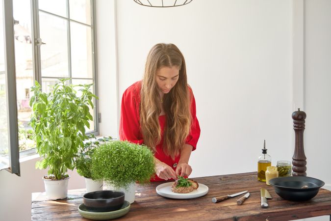Woman preparing steak tartar in kitchen at home