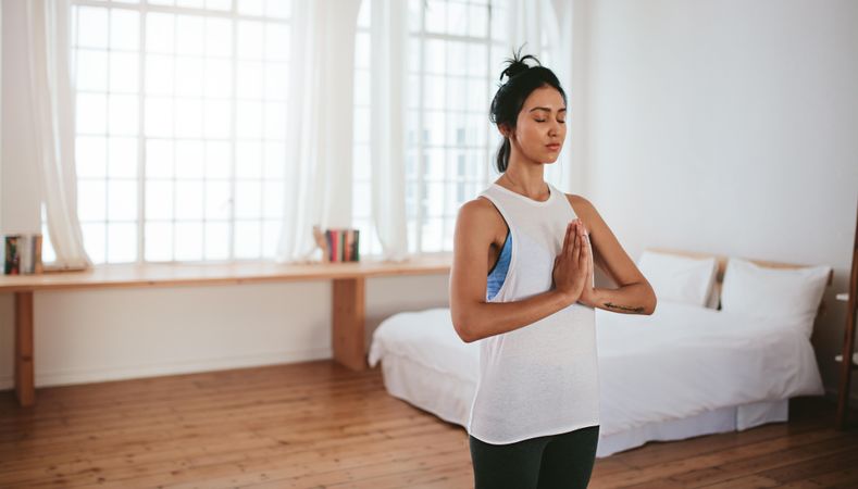 Fitness female meditating indoors