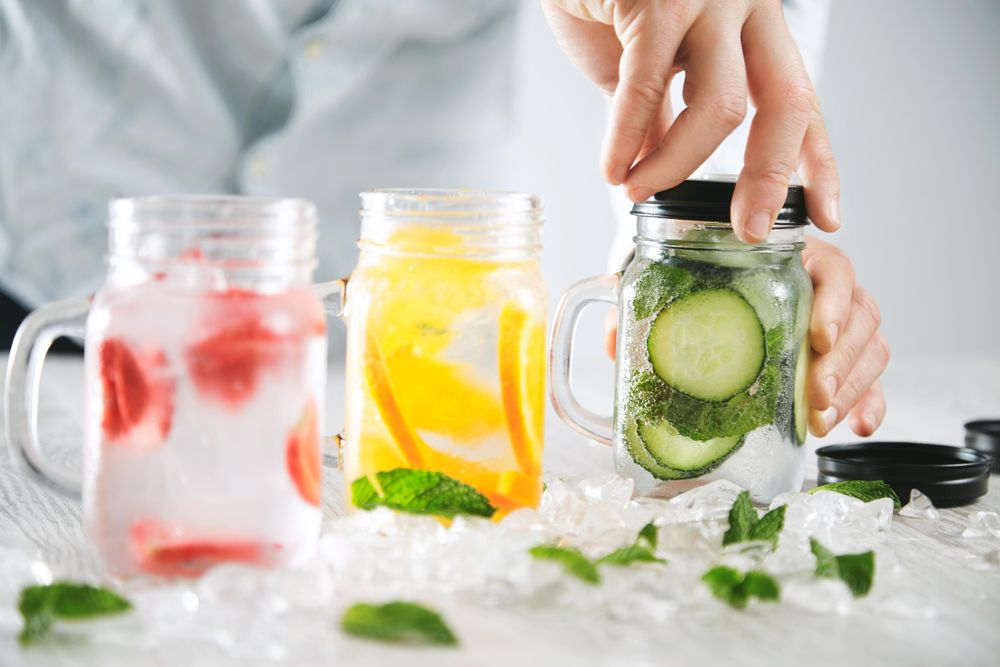Man closing top on infused water drink