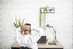 Back view of middle aged working in his home office