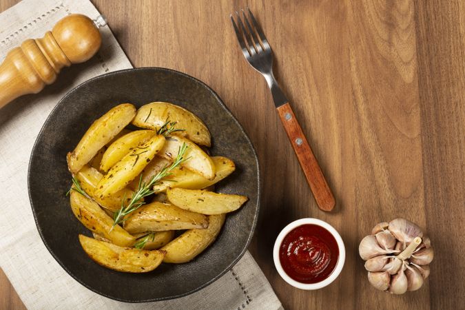 Roasted potatoes with rosemary on the plate.