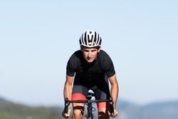 Professional cyclist riding bike in park