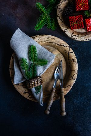 Top view of holiday table setting with gift boxes and fir branches