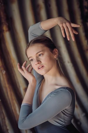 Woman dancing ballet in shabby tunnel