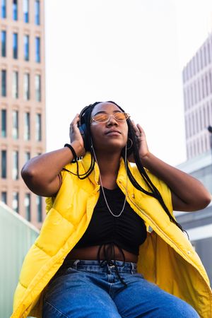 Glad female listening to music in city