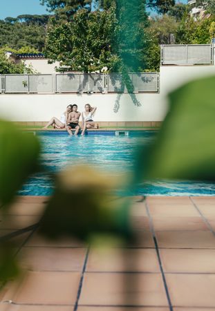 Group of friends sunbathing by the pool