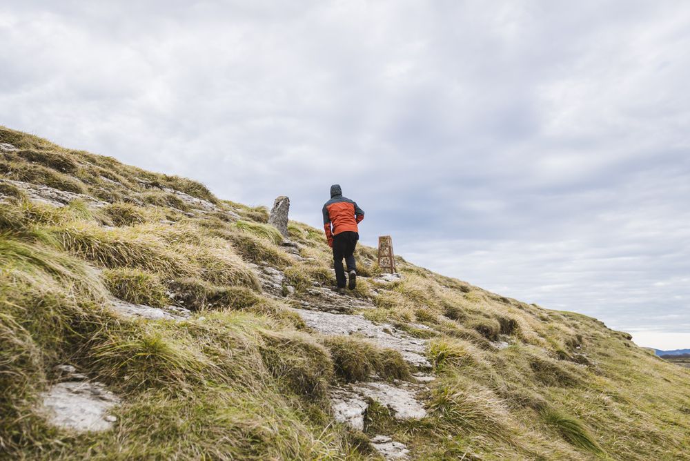Man walking on hill near valley
