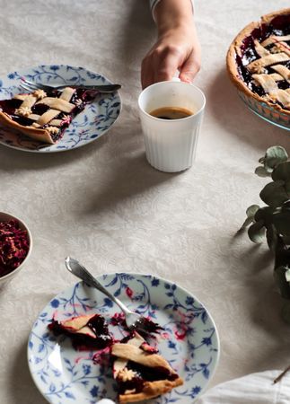Faceless person enjoying coffee with homemade pie