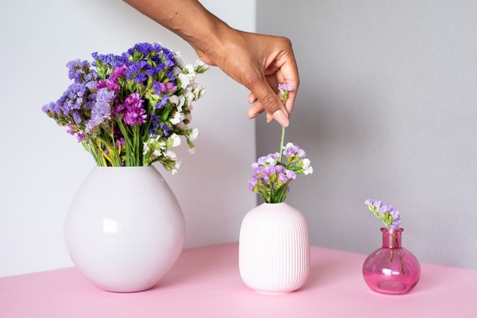 Hand fixing a bouquet of sea lavender flowers