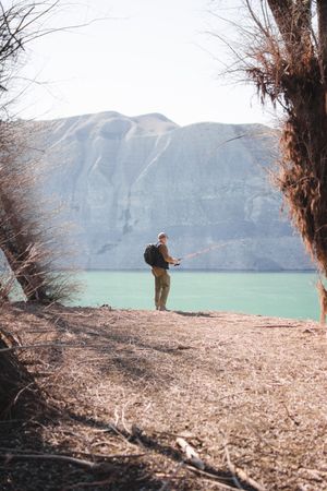 Man fishing near lake