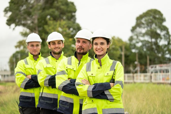 Engineer worker in arms crossed standing in a row looking smile to camera