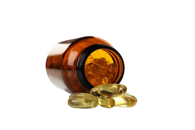 Brown bottle with omega pills, isolated on blank background