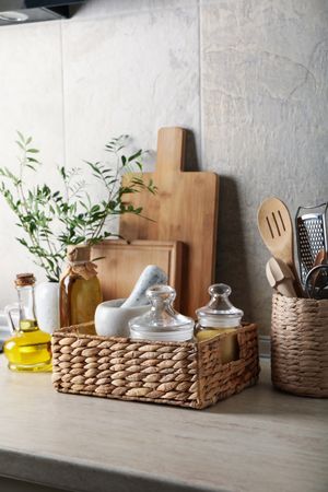 Kitchen table with different supplies and vase with plant