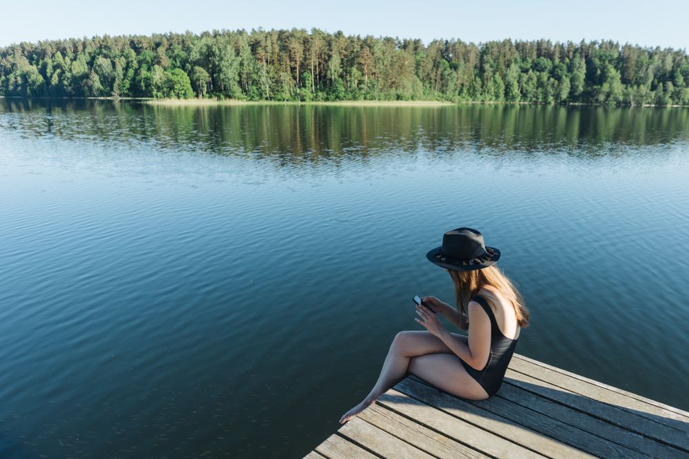 Young female sitting on smartphone