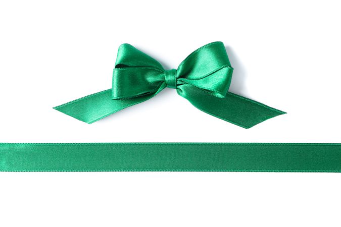 Green ribbon and bow isolated on plain background. Gift concept