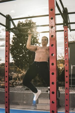 Young fitness man doing chin-ups