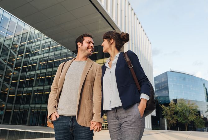 Businesspeople couple outside contemporary building