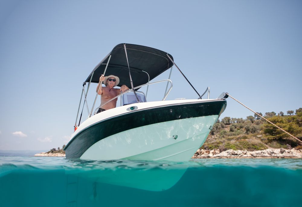 Man sailing in boat in clear turquoise water