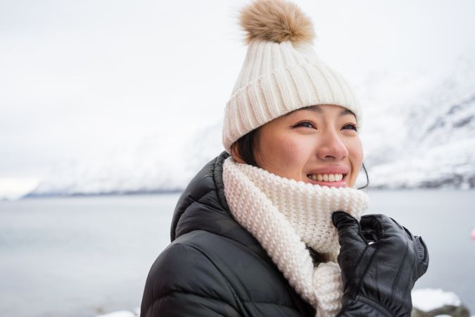 Joyful young woman in warm clothes