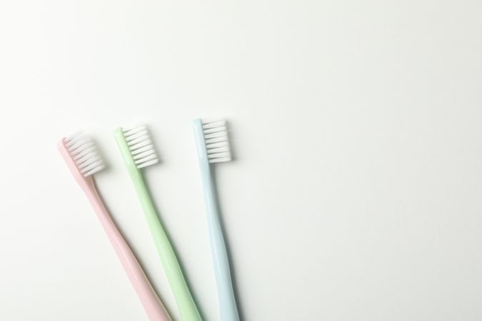 Toothbrushes on light background, top view. Dental care