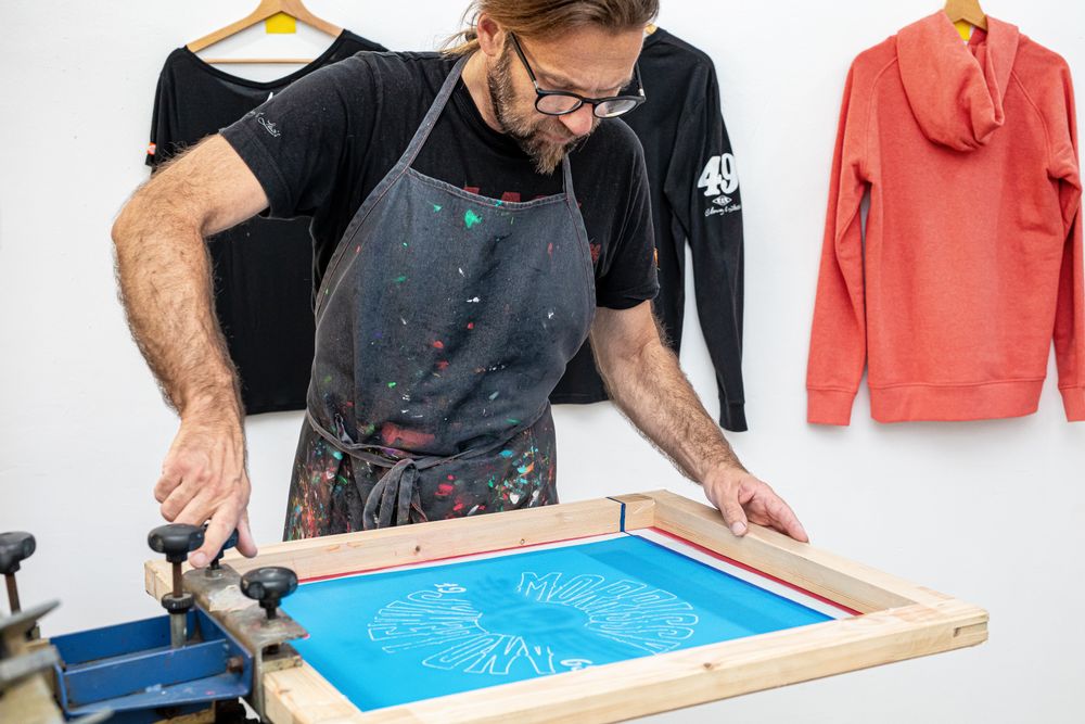 Artist printing screen in workshop