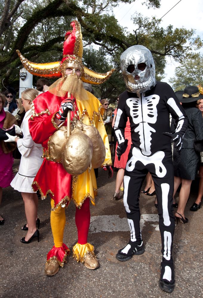Mardi Gras revelers in jester hat and skeleton costume in Mobile, Alabama
