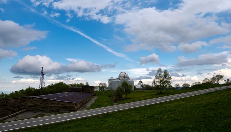 Observatory with dome structures on grassy hill