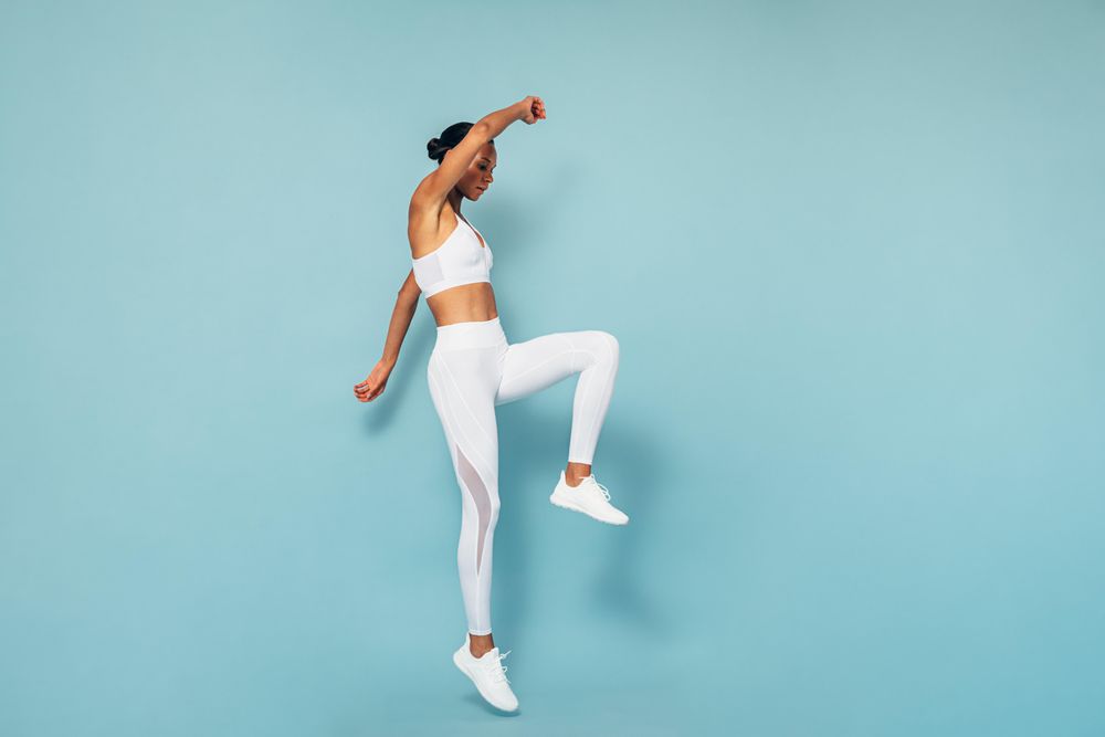 Sports woman jumping in studio